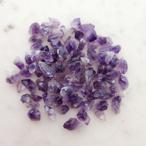 Tiny natural amethyst points with soft purple colouring and raw form