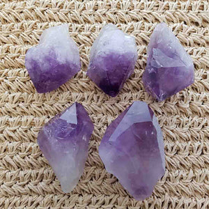 Natural amethyst points with soft purple colouring and raw pointed form