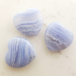 Blue Lace Agate heart with soft blue and white banding in a polished crystal heart shape