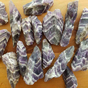 Chevron amethyst rough point showing natural purple and white banding.