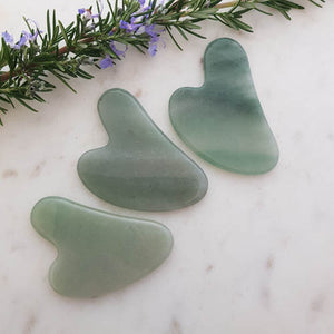 Green Aventurine gua sha tool in soft polished form.