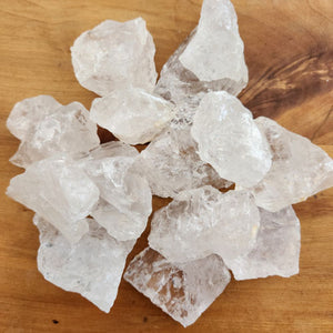 Raw clear quartz piece with pale translucent colouring and rough texture.