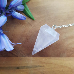 Faceted rose quartz pendulum hanging on a delicate silver chain