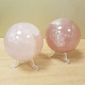 Polished rose quartz spheres showing soft pink tones.