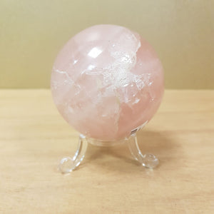 Polished rose quartz sphere showing soft pink colour and smooth finish.