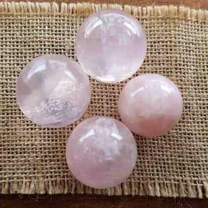 Polished rose quartz sphere in soft pale pink